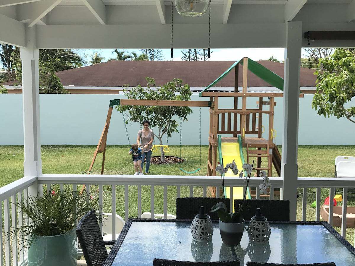 Covered timber porch with beadboard ceiling and white railings, Blair Estates, April 2017
