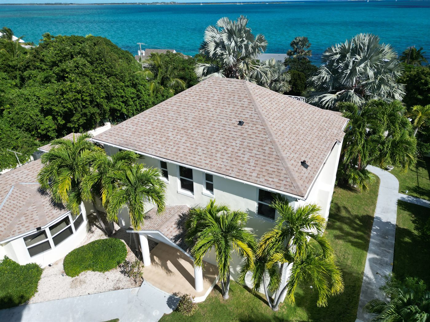 Brown residence, beachfront two-storey home under structural renovation, from the air