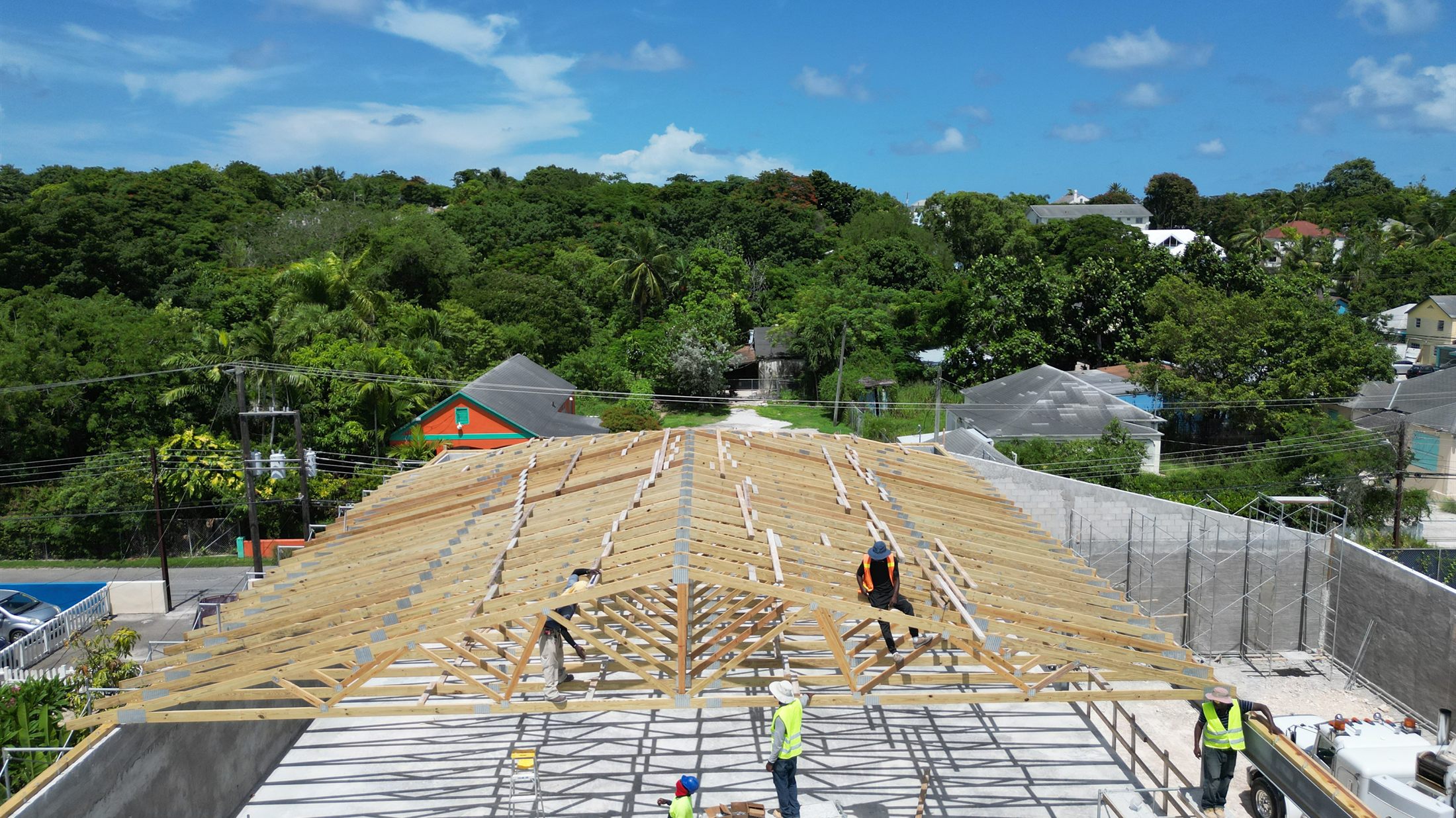Hammerhead crew setting roof trusses on John's Department Store at 6th Terrace, Nassau, September 2026