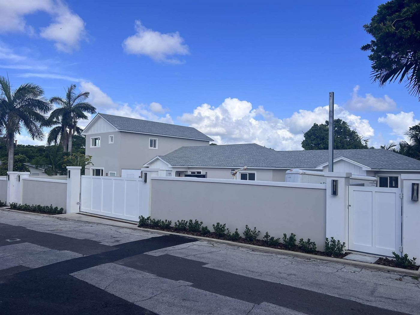 Harmony Hill triplex, three finished units behind the new boundary wall, July 2023
